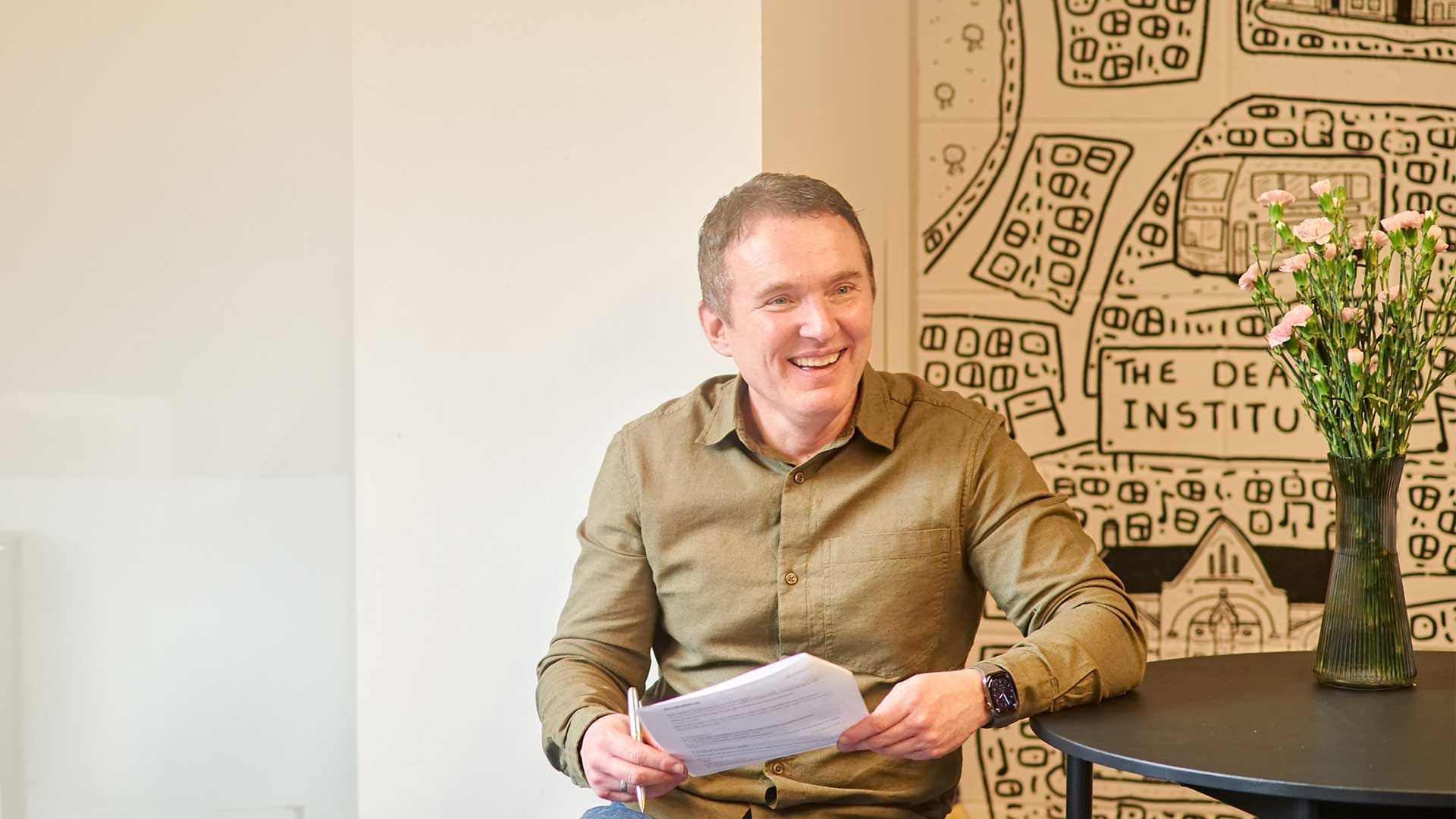 Director smiling during briefing meeting