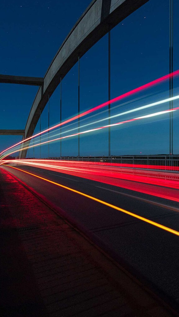 Trailing car lights over bridge